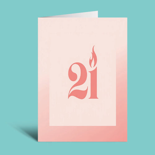 A minimalist greeting card or art print with a pale pink background, featuring the number 21 stylized in coral-red with a flame motif, shown standing against a solid turquoise background.