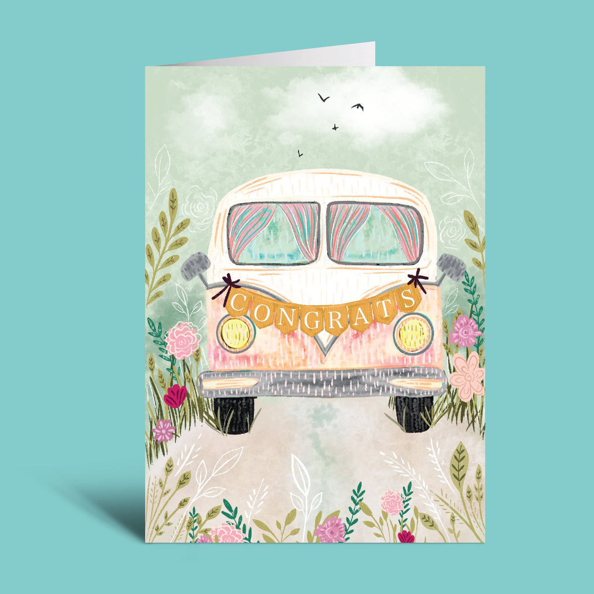 An image of a vintage VW bus decorated for a wedding with a congrats banner hanging on the front with flowers and a pastel color theme