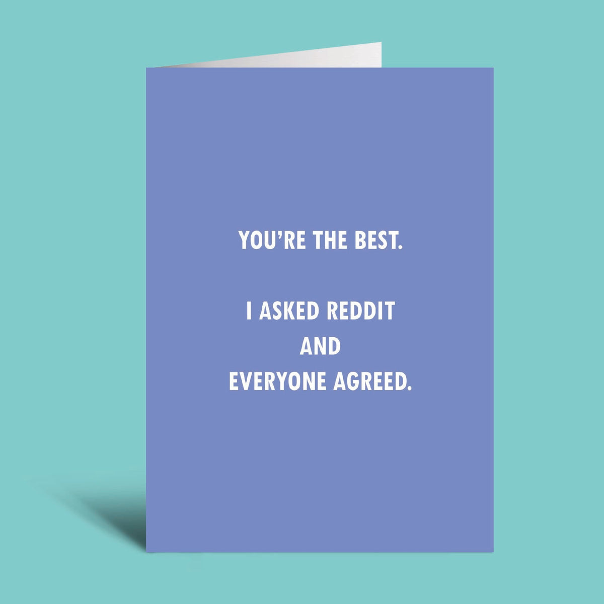 A folded greeting card standing upright on a teal background. The card is lavender-blue with white text that reads, 'YOU'RE THE BEST.