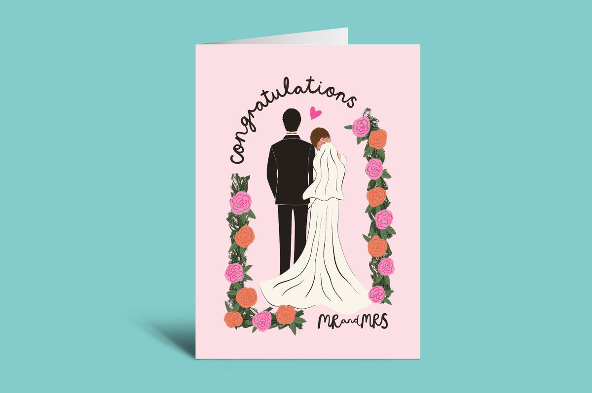 Wedding card with a couple illustration and 'Congratulations Mr. and Mrs.' text on a pink background.
