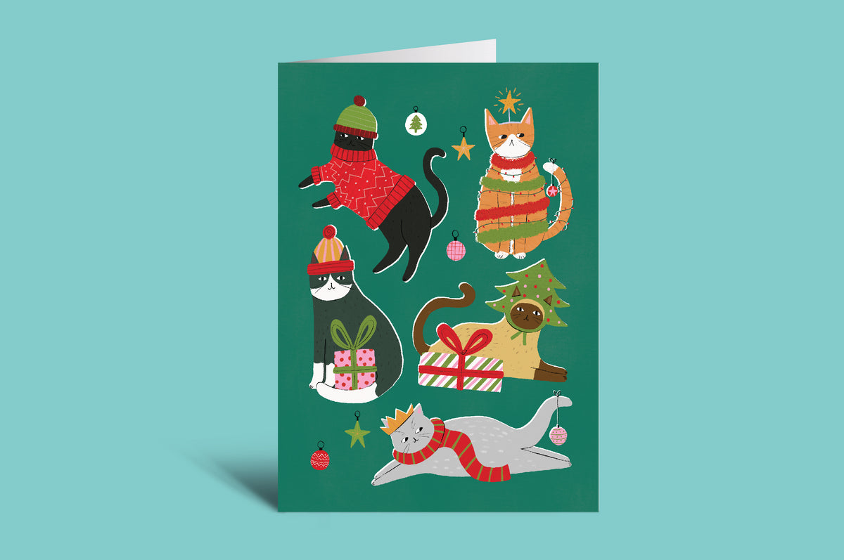 Greeting card with illustrations of cats in festive attire on a green background