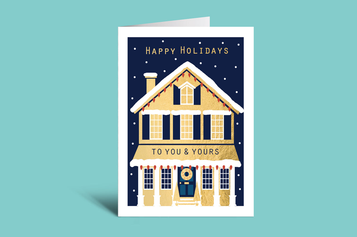 Holiday card with a house illustration and 'Happy Holidays to you & yours' text on a teal background