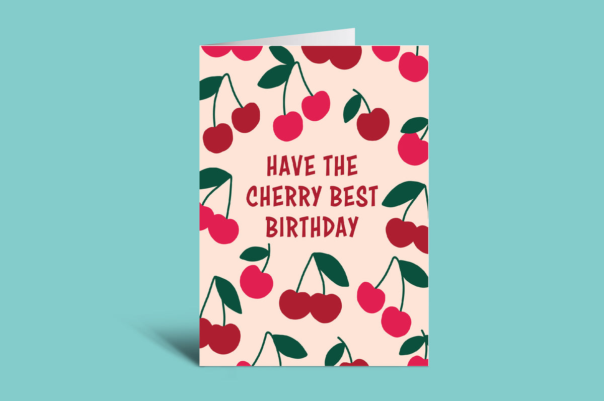 Greeting card with cherry design and text on a pink background