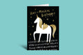 Greeting card with unicorn illustration and 'Have a Magical Birthday!' text on a teal background