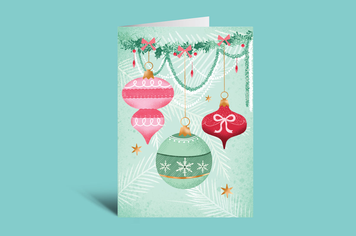 Decorative greeting card with colorful Christmas ornaments on a green background