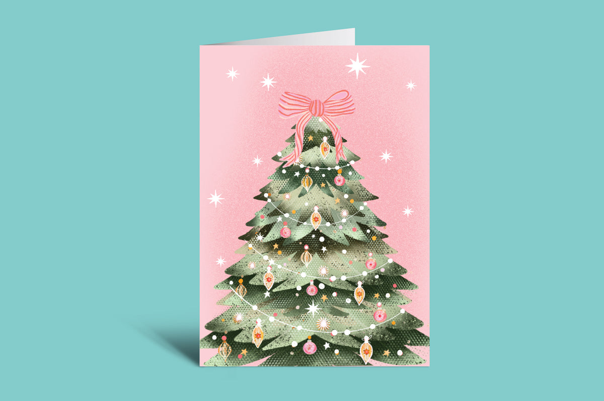 Christmas card with a decorated Christmas tree on a pink background
