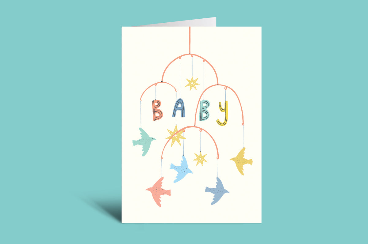 Greeting card with colorful baby mobile design and 'BABY' text on a green background