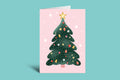 Christmas tree card with colorful decorations on a pink background