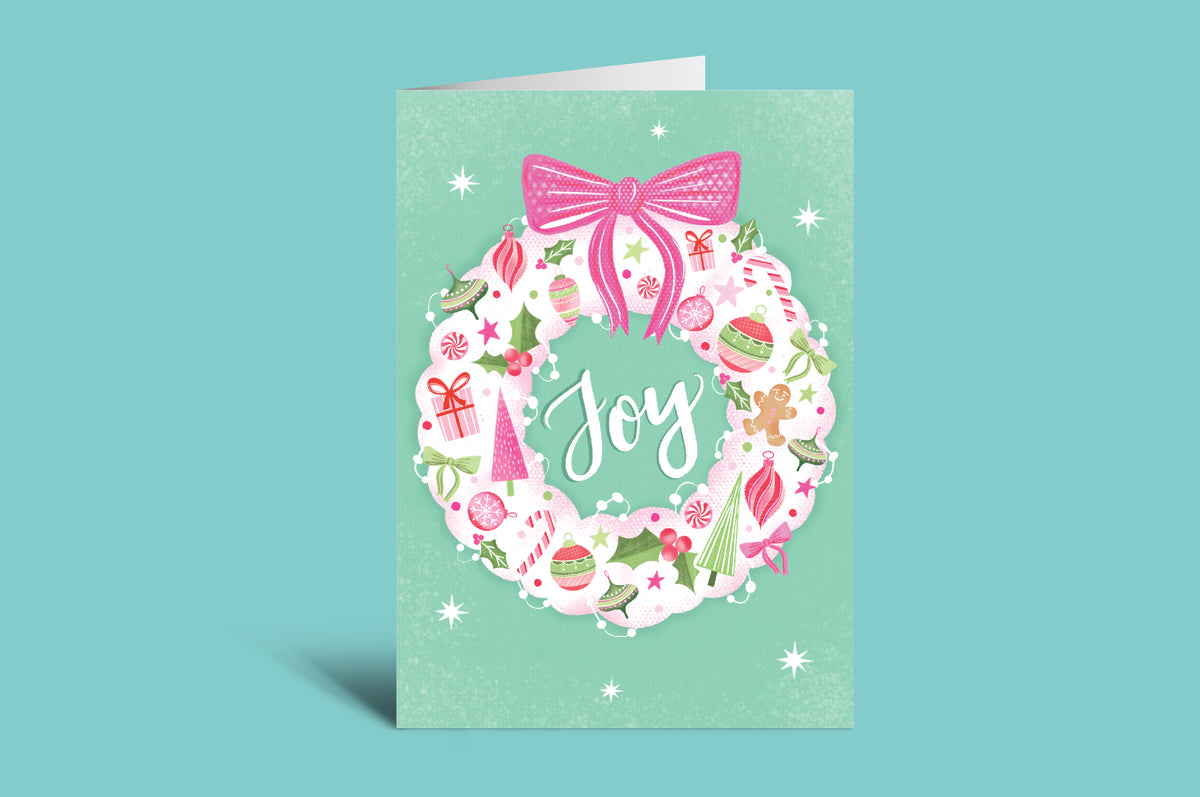 Greeting card with 'Joy' text and festive design on a green background