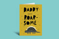 Greeting card with 'Daddy, you're roar-some' text and a dinosaur illustration on a green background