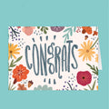 Greeting card with floral design and 'CONGRATS' text on a teal background