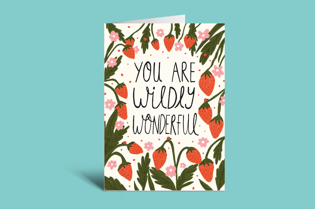 Greeting card with strawberry design and text 'You are wildly wonderful' on a teal background