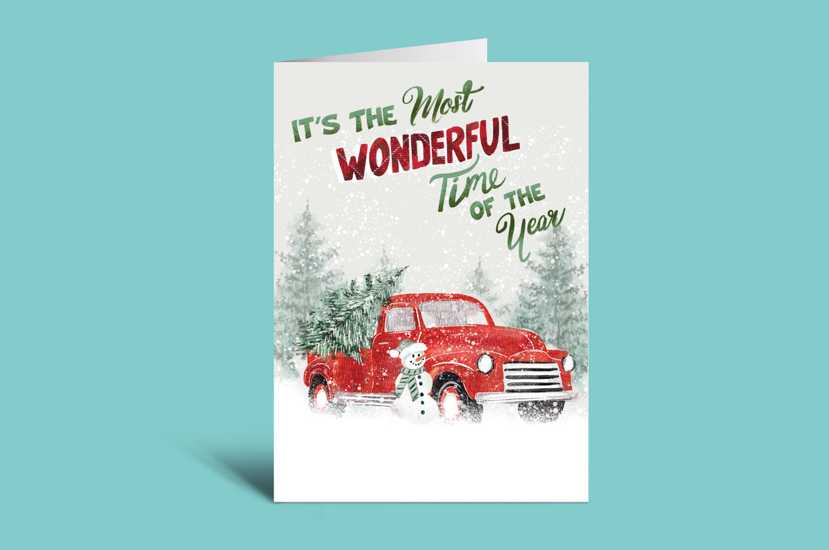 Christmas card with red truck and 'It's the Most Wonderful Time of the Year' text on a green background
