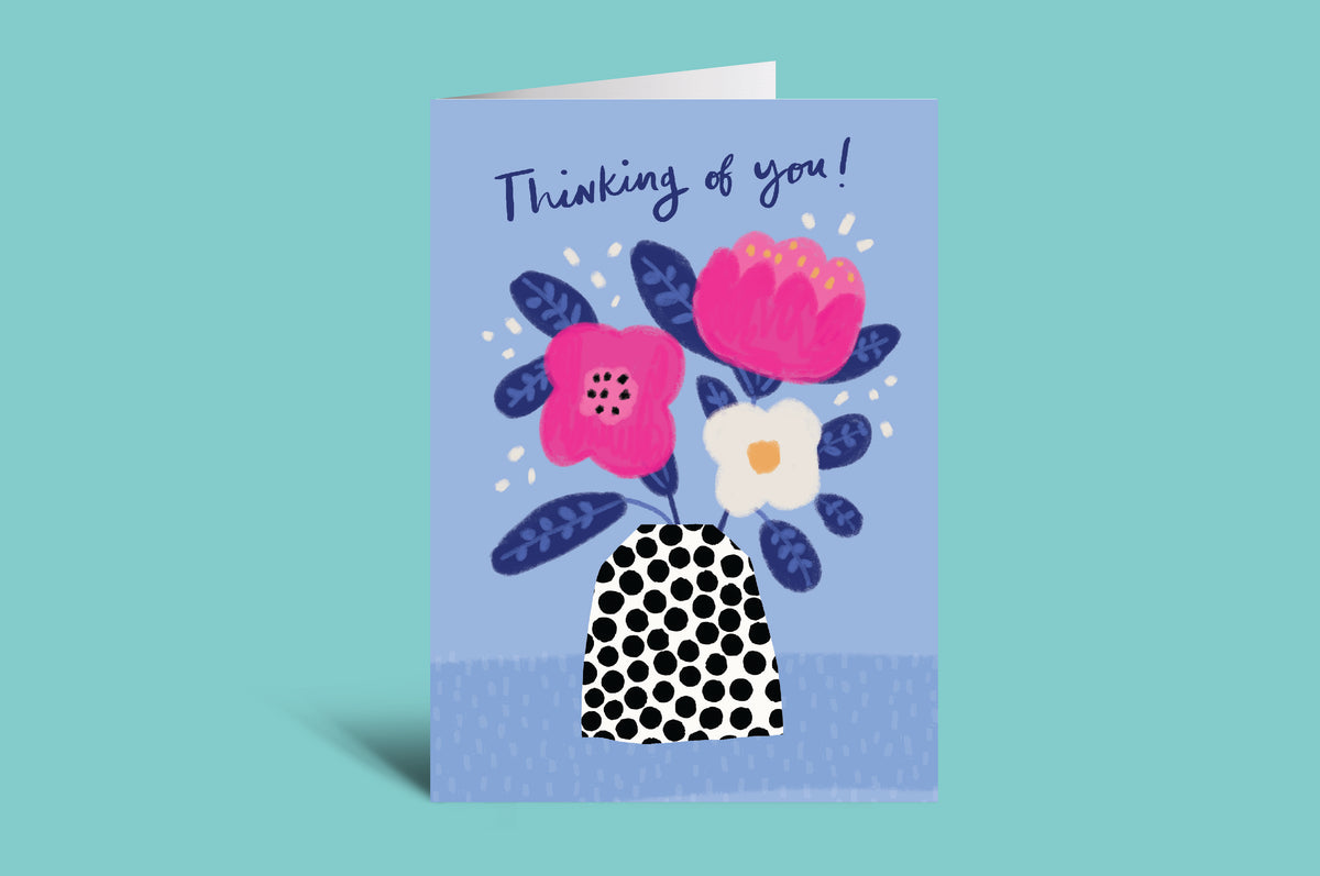 Greeting card with floral design and 'Thinking of you!' text on a light green background